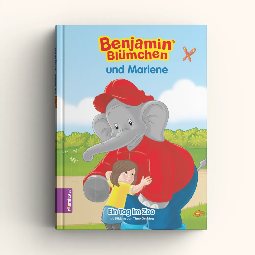 Das Buchcover "Benjamin Blümchen und du" von Framily zeigt Benjamin Blümchen, den freundlichen grauen Elefanten mit rotem Hemd und Mütze, der ein lächelndes Mädchen in einer grünen Zoolandschaft unter blauem Himmel umarmt.